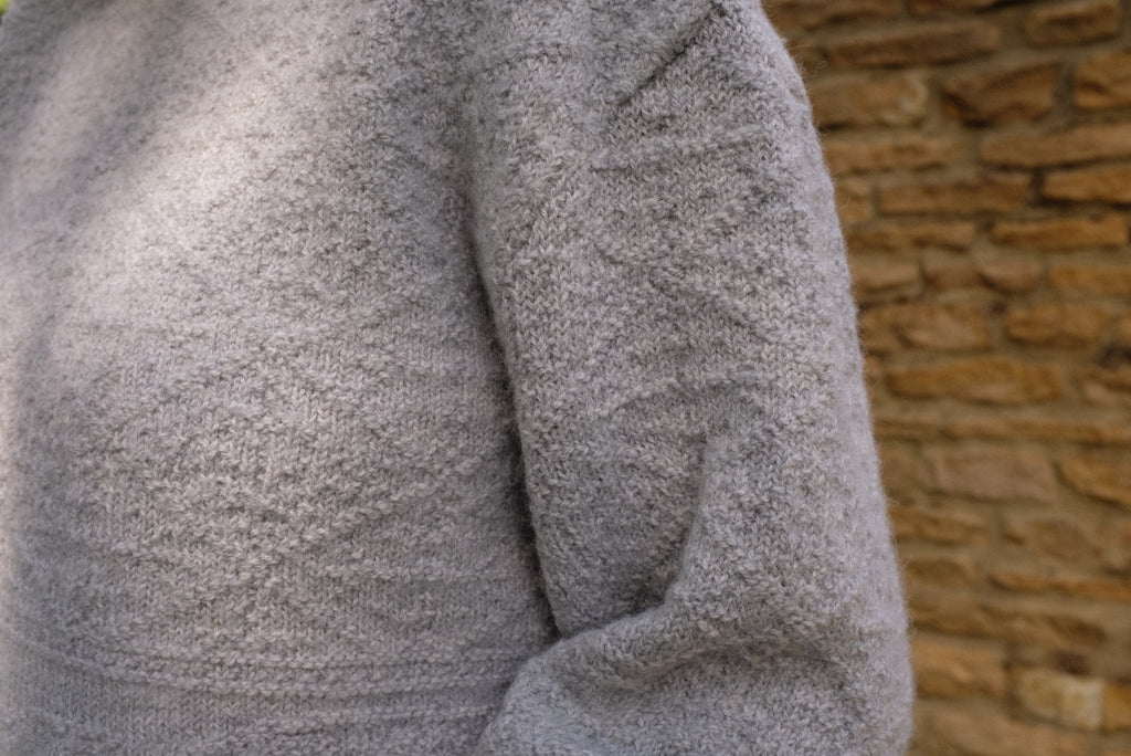 Detail of the Cloud Stitch Jumper in grey, showcasing its textured stitch for sustainable knitwear jumper.